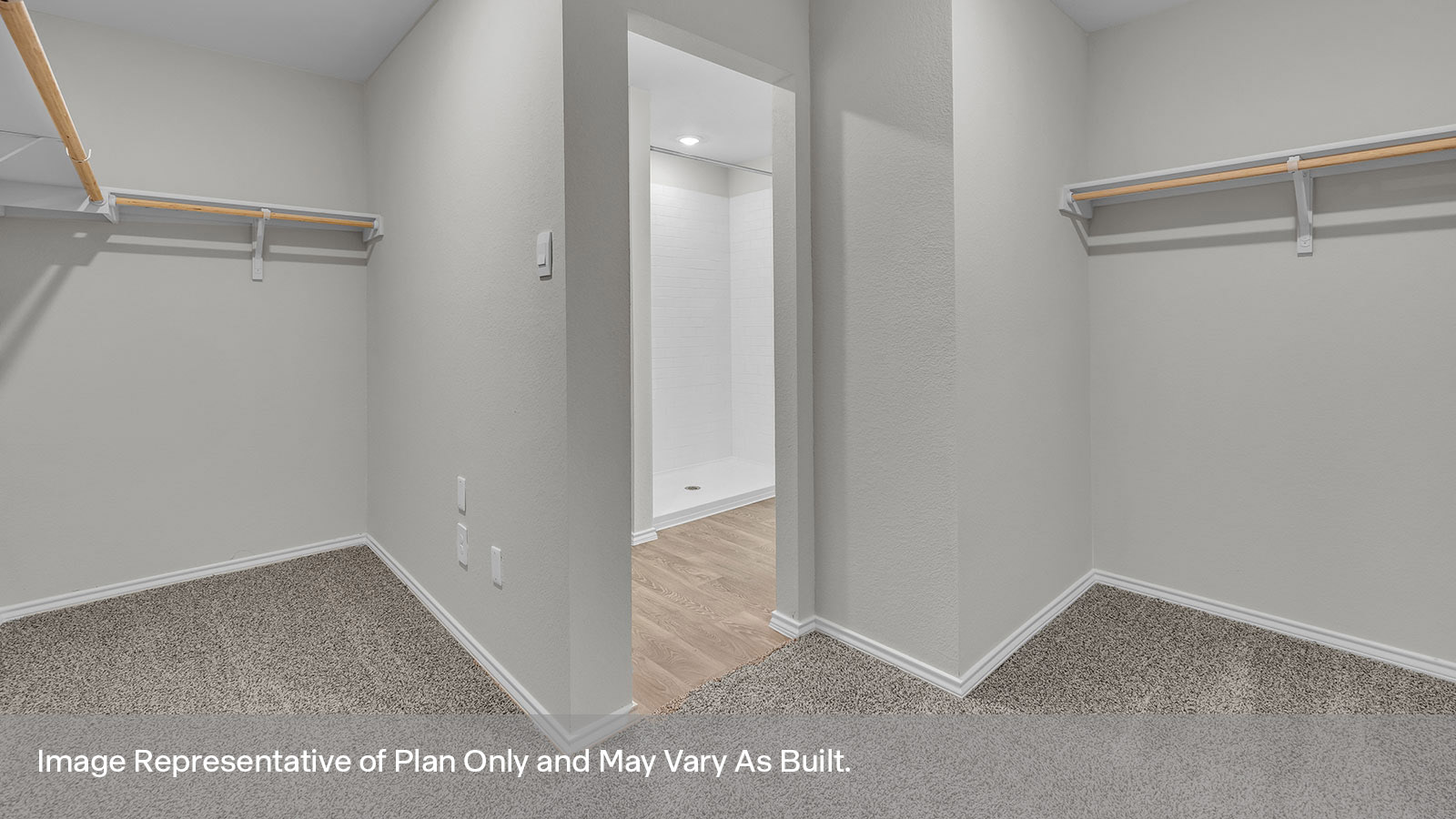 Main bedroom closet with carpeting and wooden shelving.