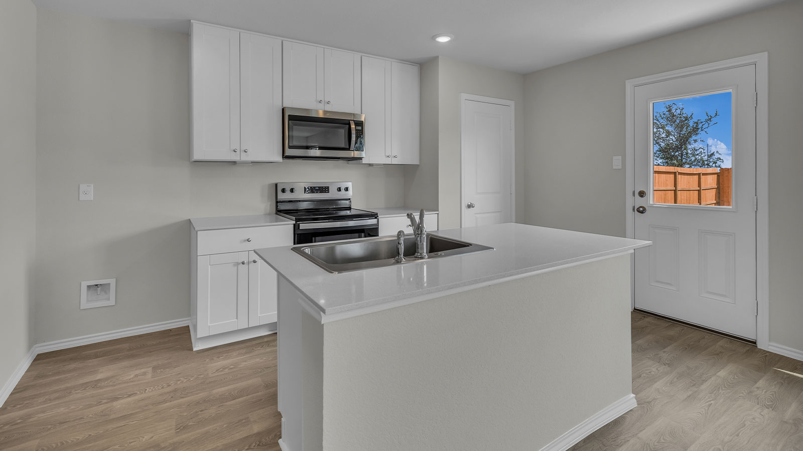Kitchen with kitchen island and white cabinets.