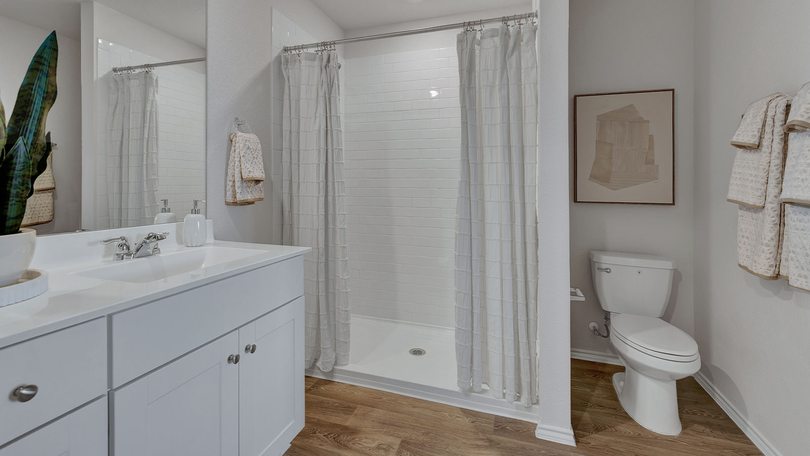 Main bathroom with shower, toilet, and sink.