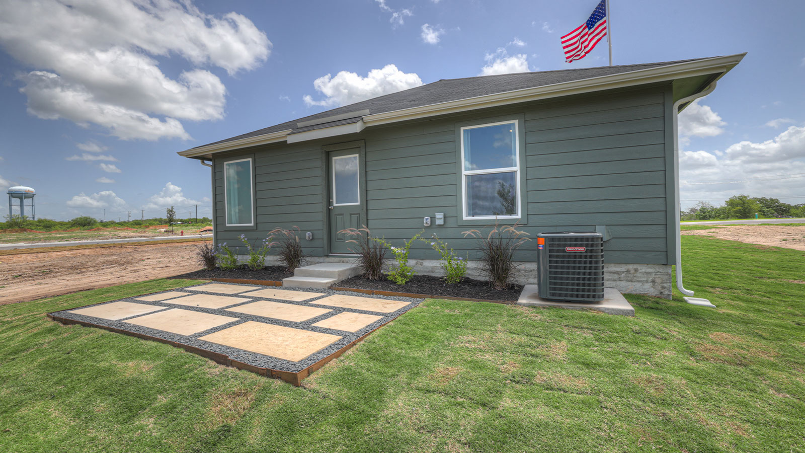 Backyard with 2 windows, and a half lite exterior door.