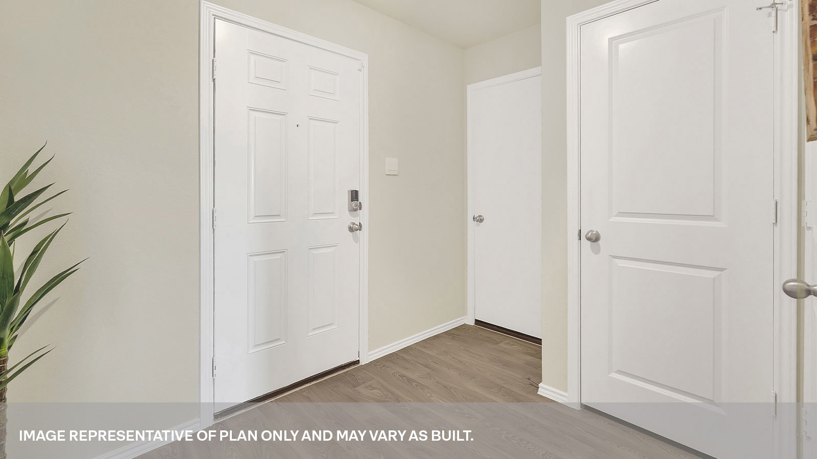 Entryway with vinyl flooring and front door.