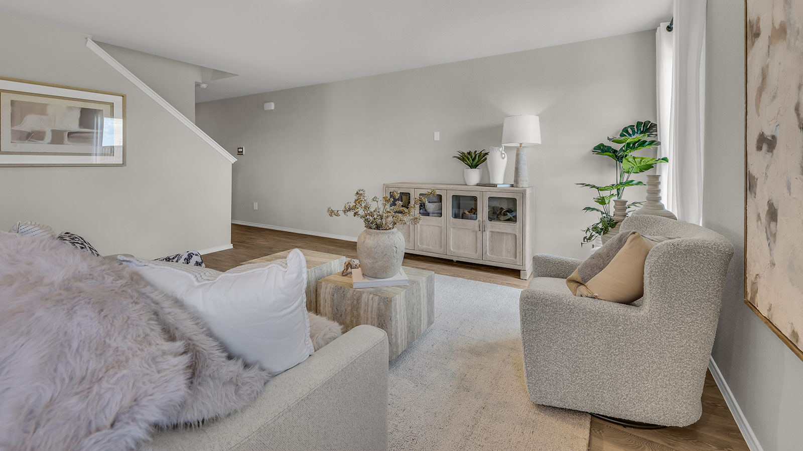 Living room with vinyl flooring, one window, and a half lite exterior door.