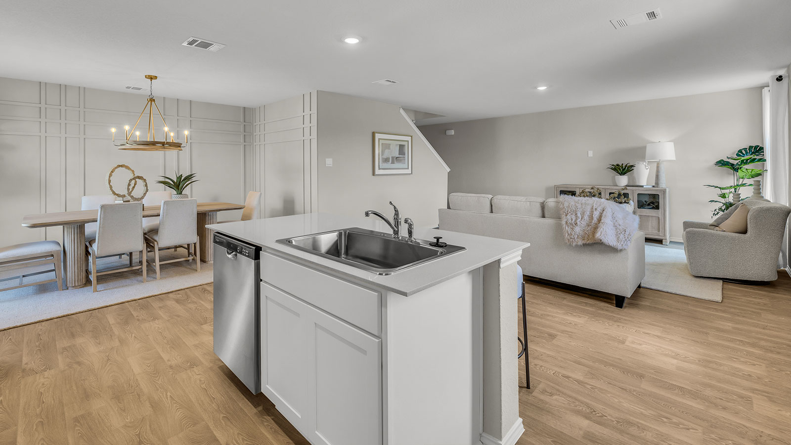 Kitchen island with quartz countertops and stainless steel appliances.