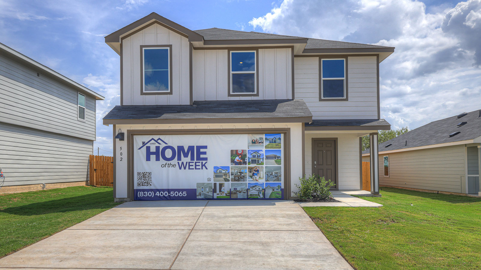 Two-story farmhouse exterior photo with 2 car garage.
