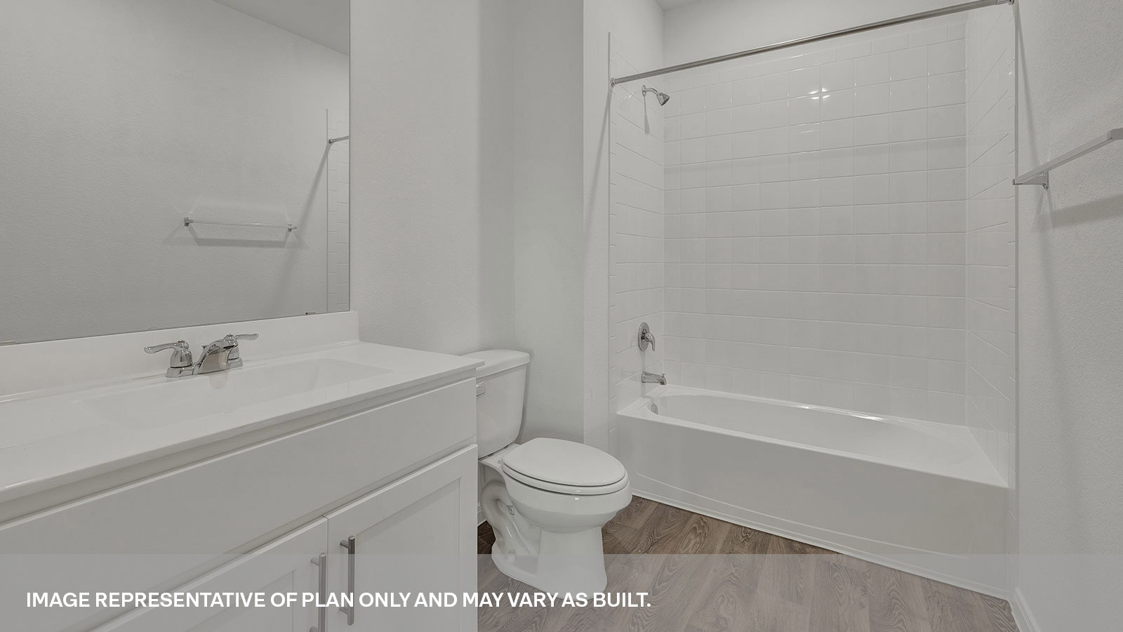 Hall bathroom with single sink vanity, toilet, and tub with tile surround.