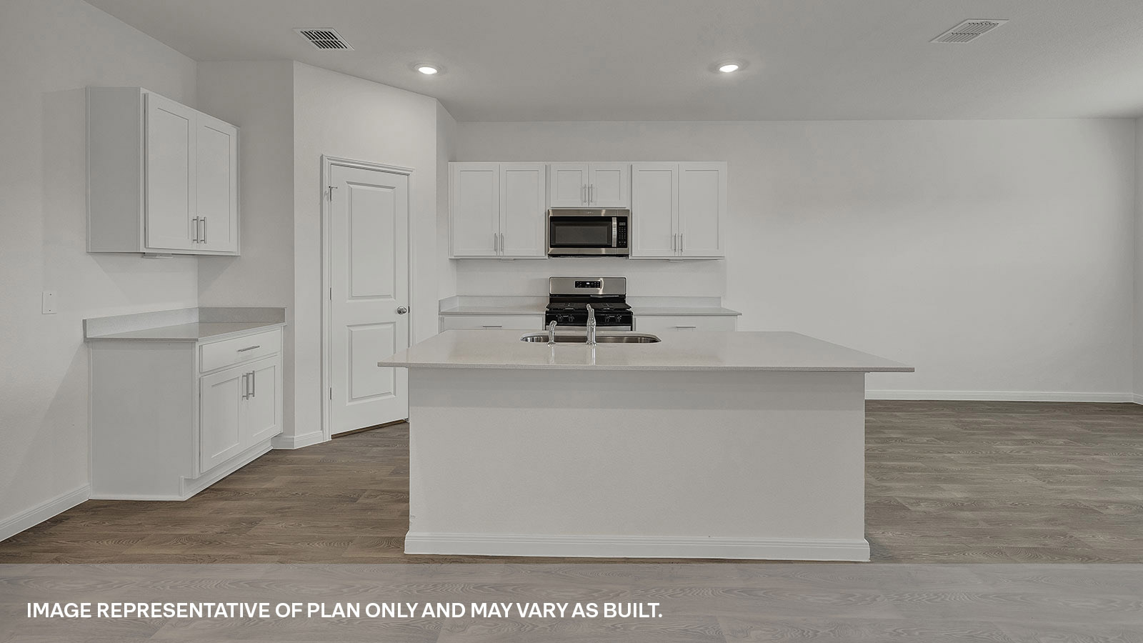 Kitchen with kitchen island and white cabinets.