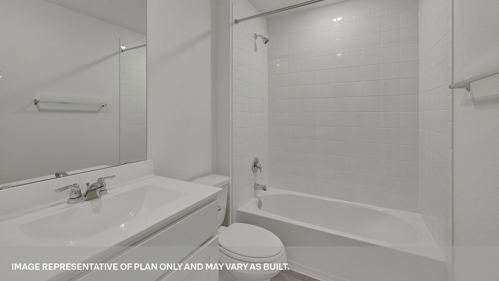 Hall bathroom with single sink vanity, toilet, and tub with tile surround.
