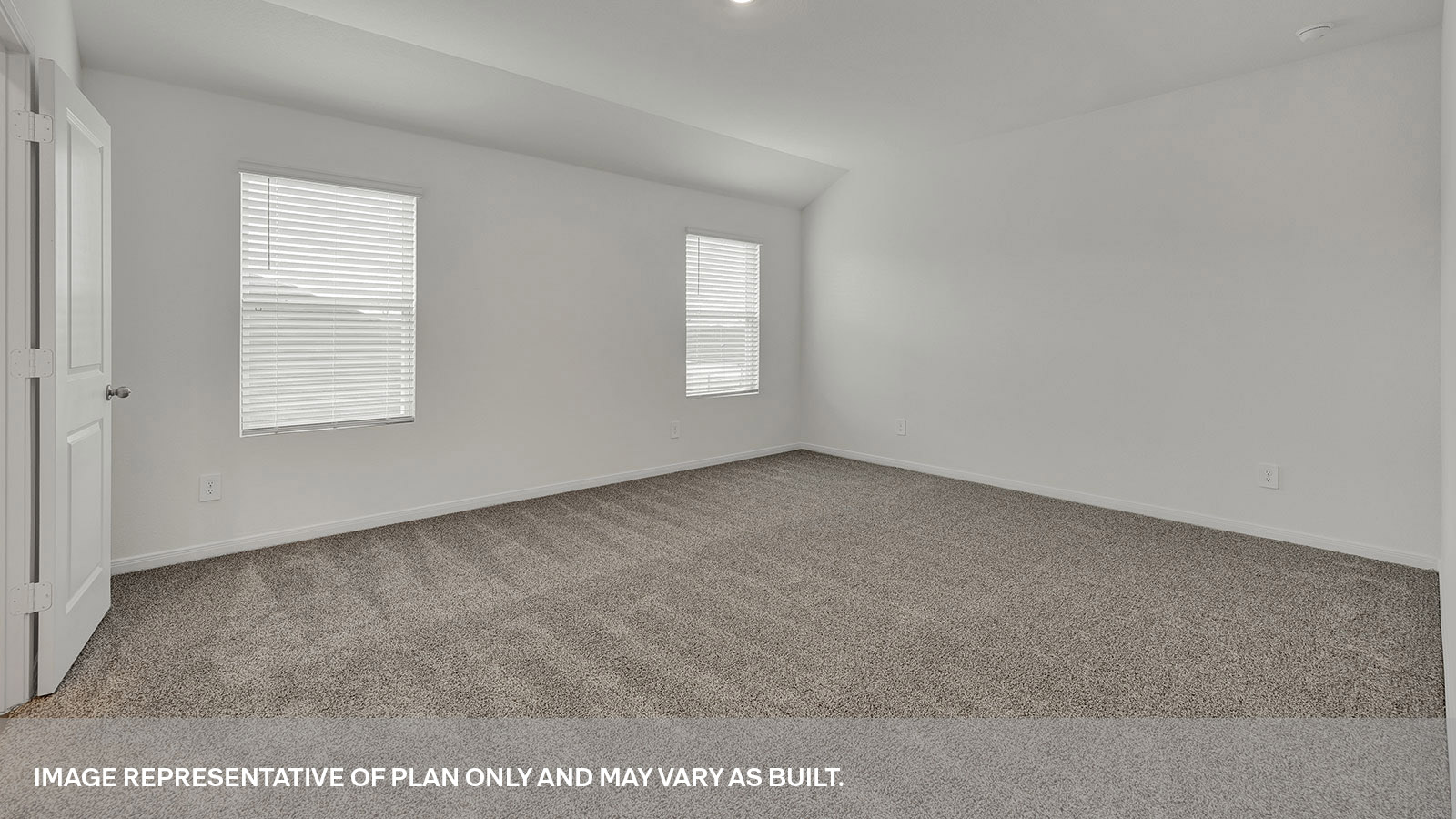 Main bedroom with carpeting and two windows.