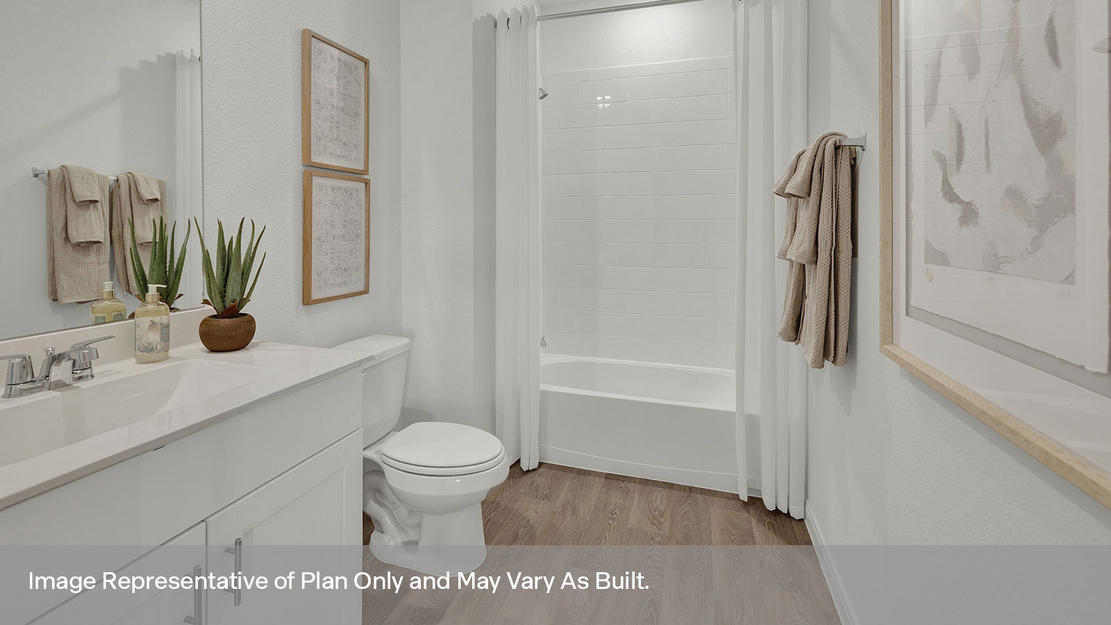 Hall bathroom with single sink vanity, toilet, and tub with tile surround.