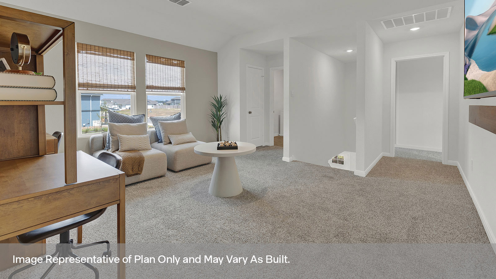 Gameroom of off the staircase with carpeting and two windows.