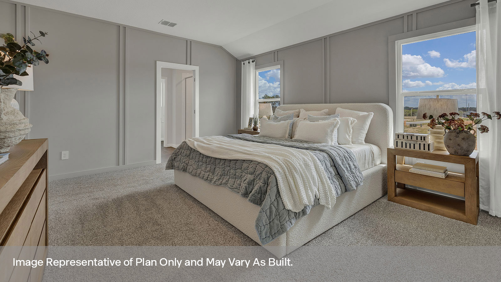Main bedroom with carpeting and two windows.