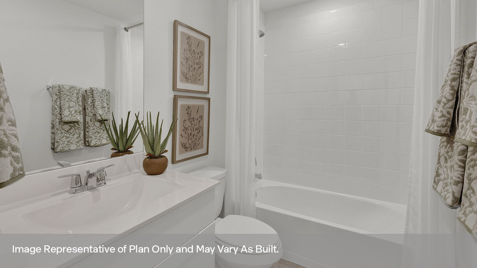 Hall bathroom with single sink vanity, toilet, and tub with tile surround.