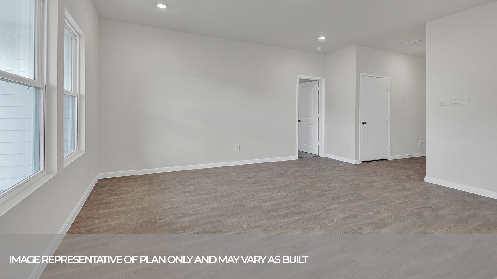 Living room and kitchen with vinyl flooring and two windows.