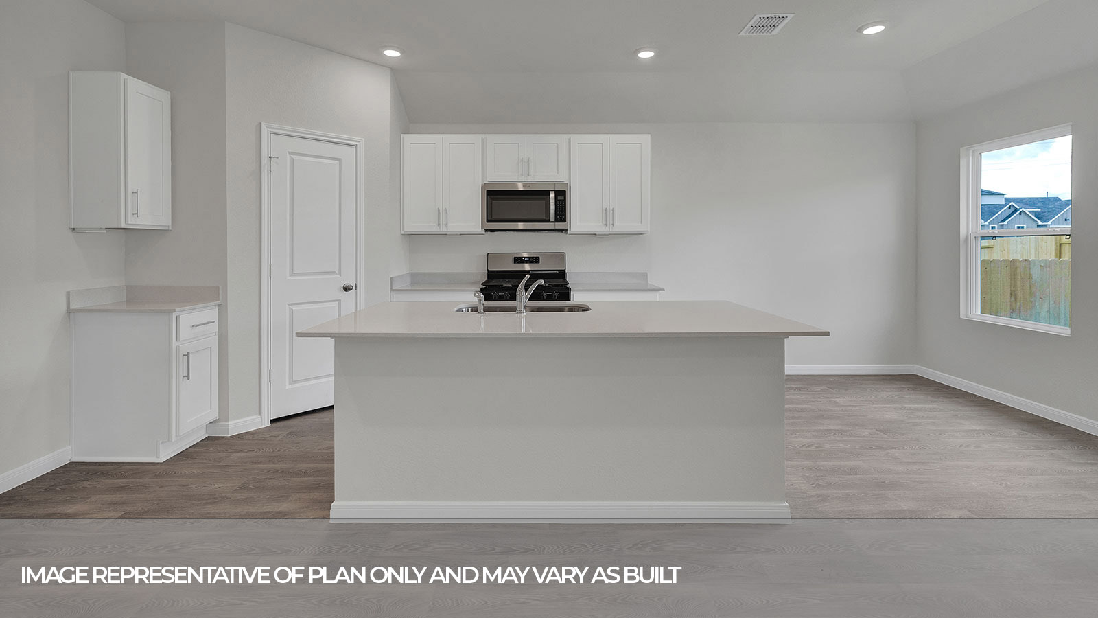 Kitchen with kitchen island and white cabinets.
