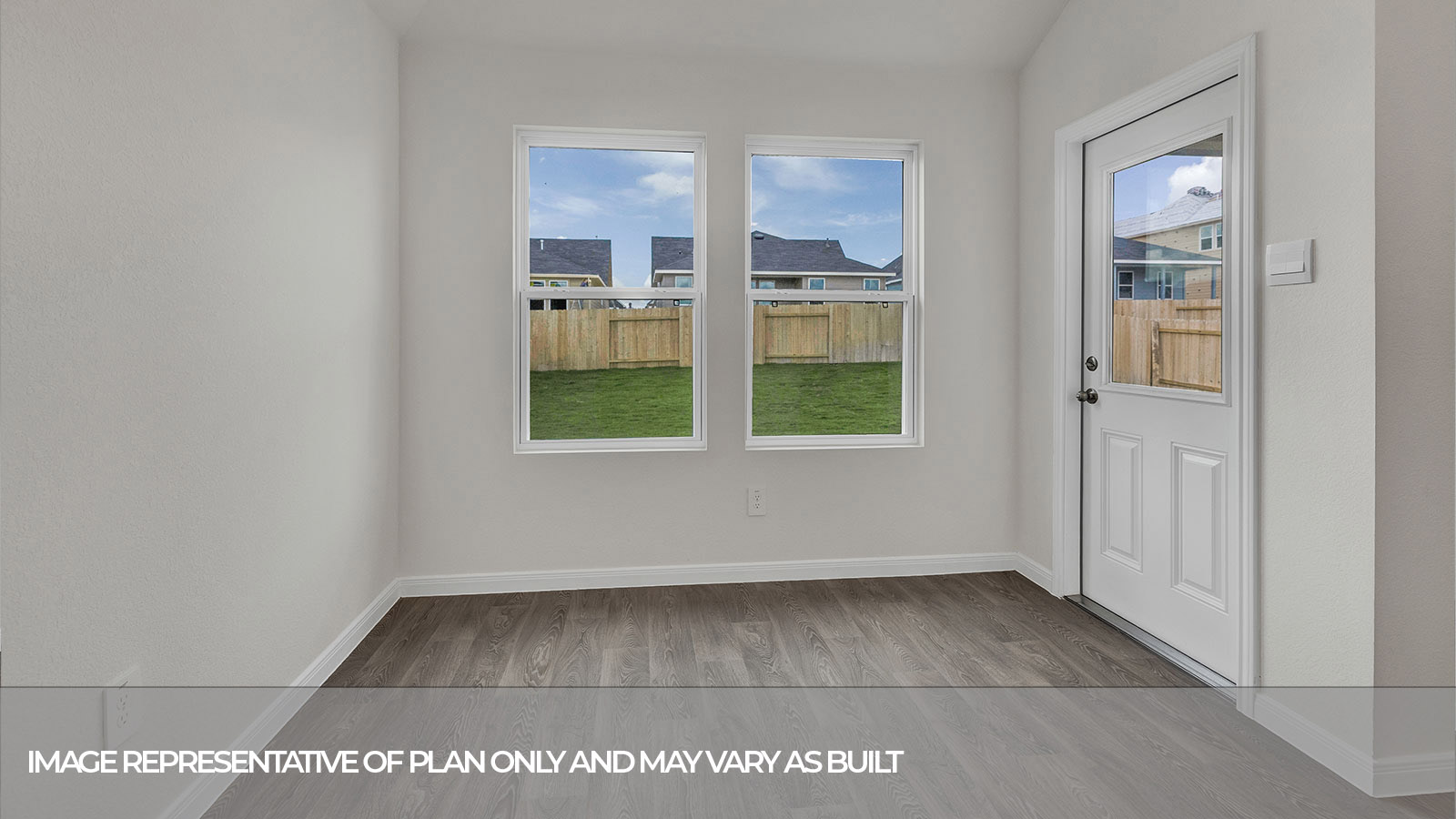 Dining room with vinyl flooring, two windows, and a half lite exterior door.