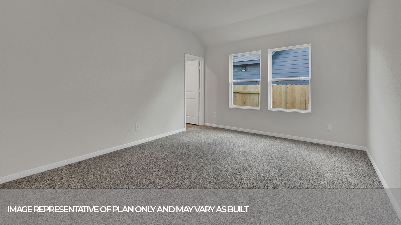 Main bedroom with carpeting and two windows.