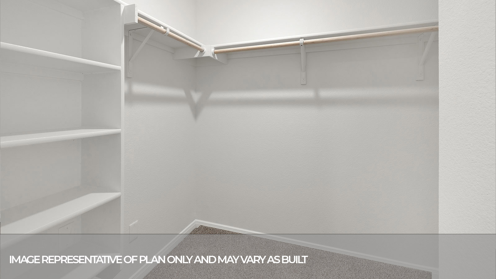 Walk-in closet with carpeting and wooden shelving.
