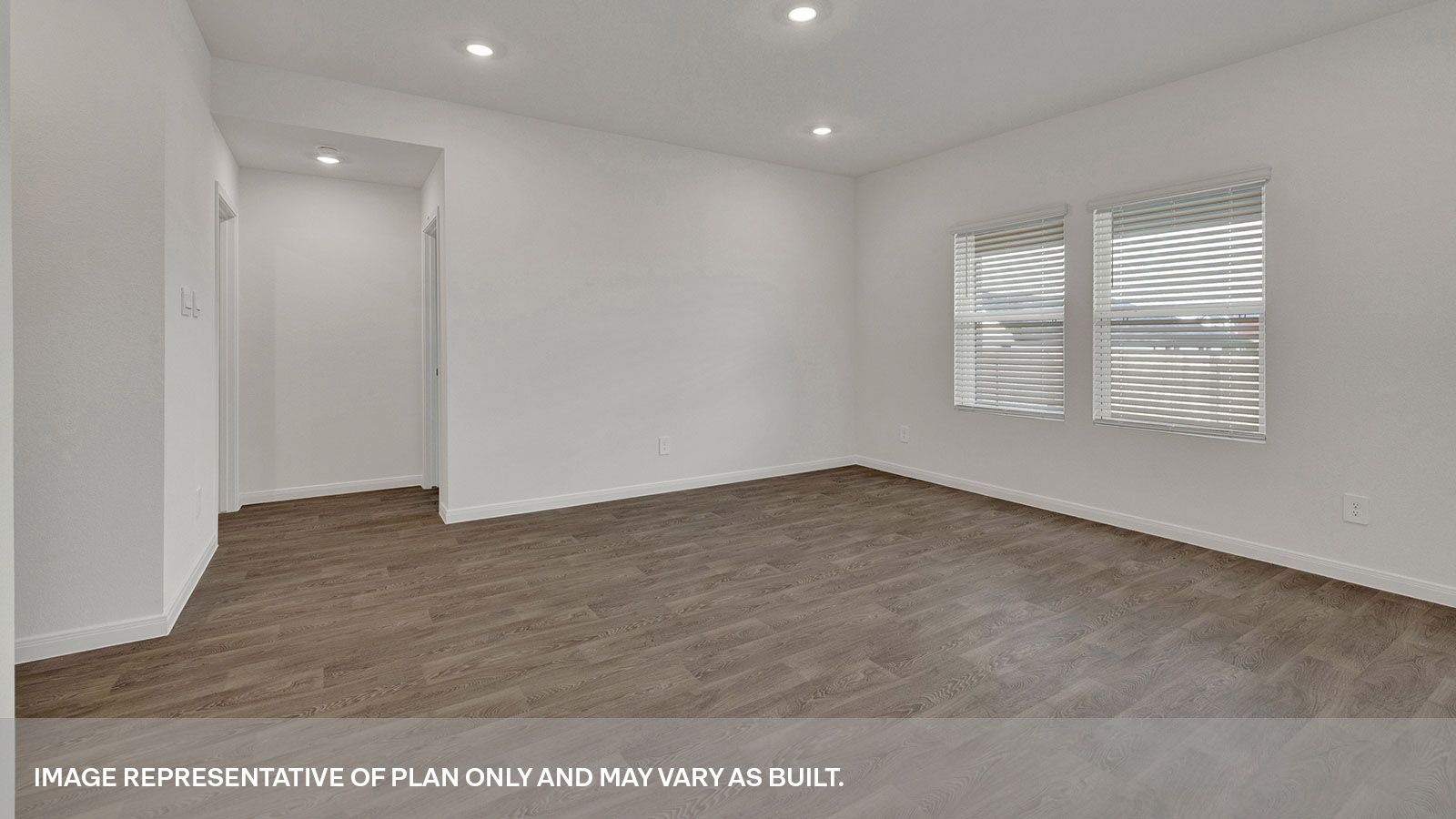 Living room with vinyl flooring and two windows.