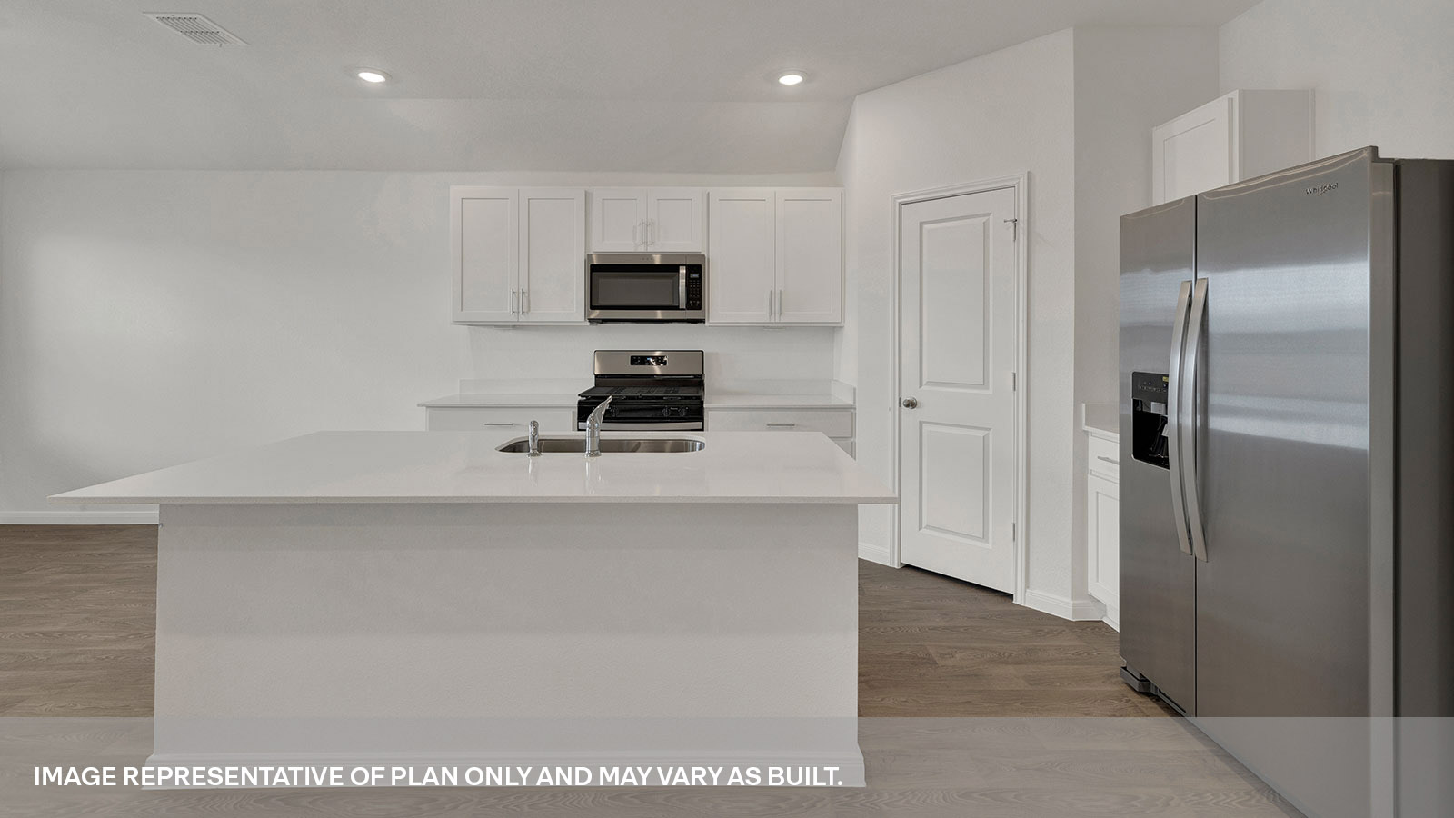 Kitchen with kitchen island and white cabinets.