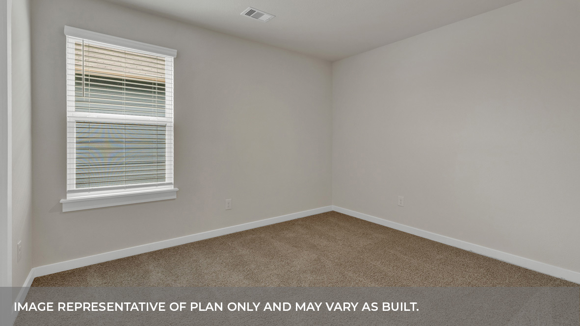 Bedroom with carpeting and one window looking into the side yard.