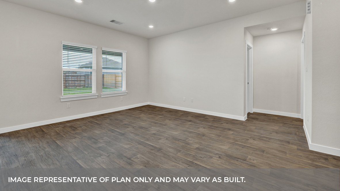 Living room with vinyl flooring and two windows.