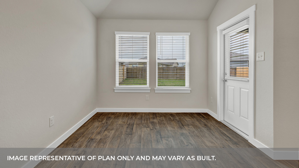 Dining room with vinyl flooring and two windows.