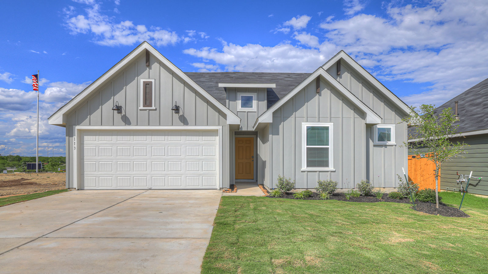 Bellvue floorplan F elevation with farmhouse exterior two windows and 2 car garage.