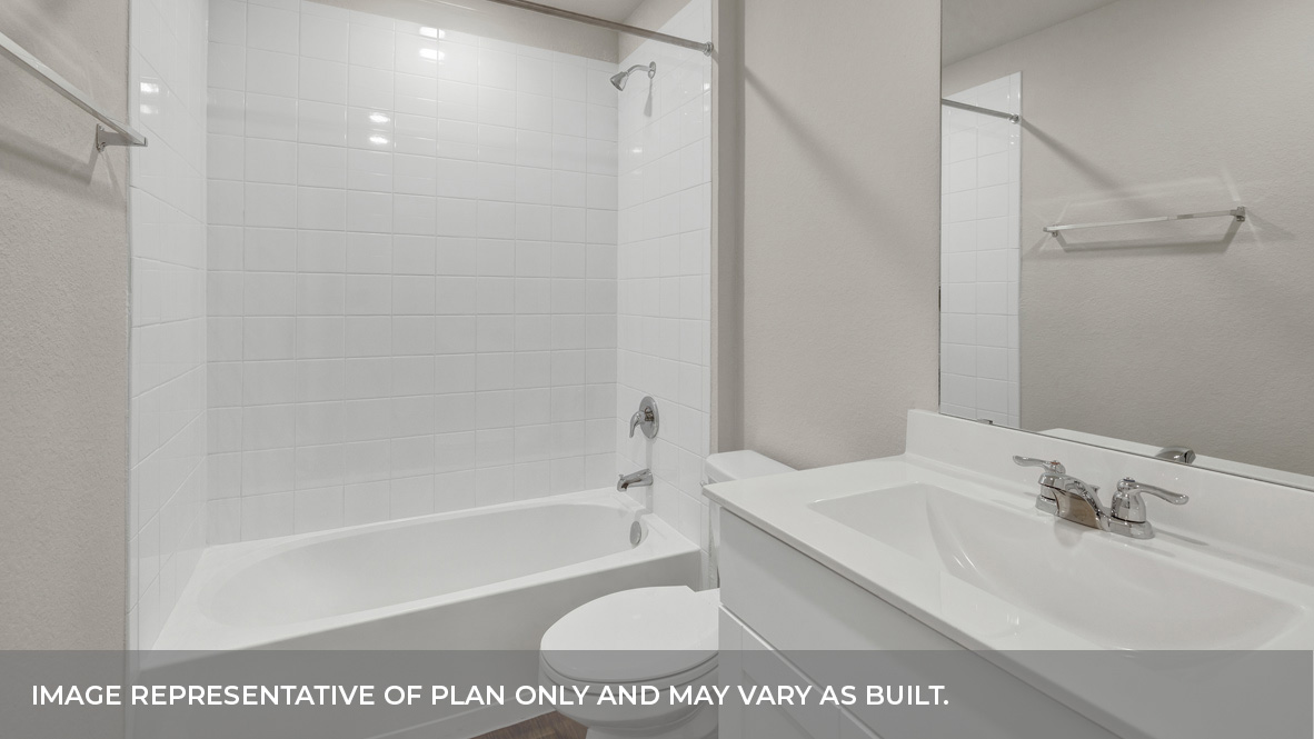 Hall bathroom with single-sink vanity, toilet, and tub.