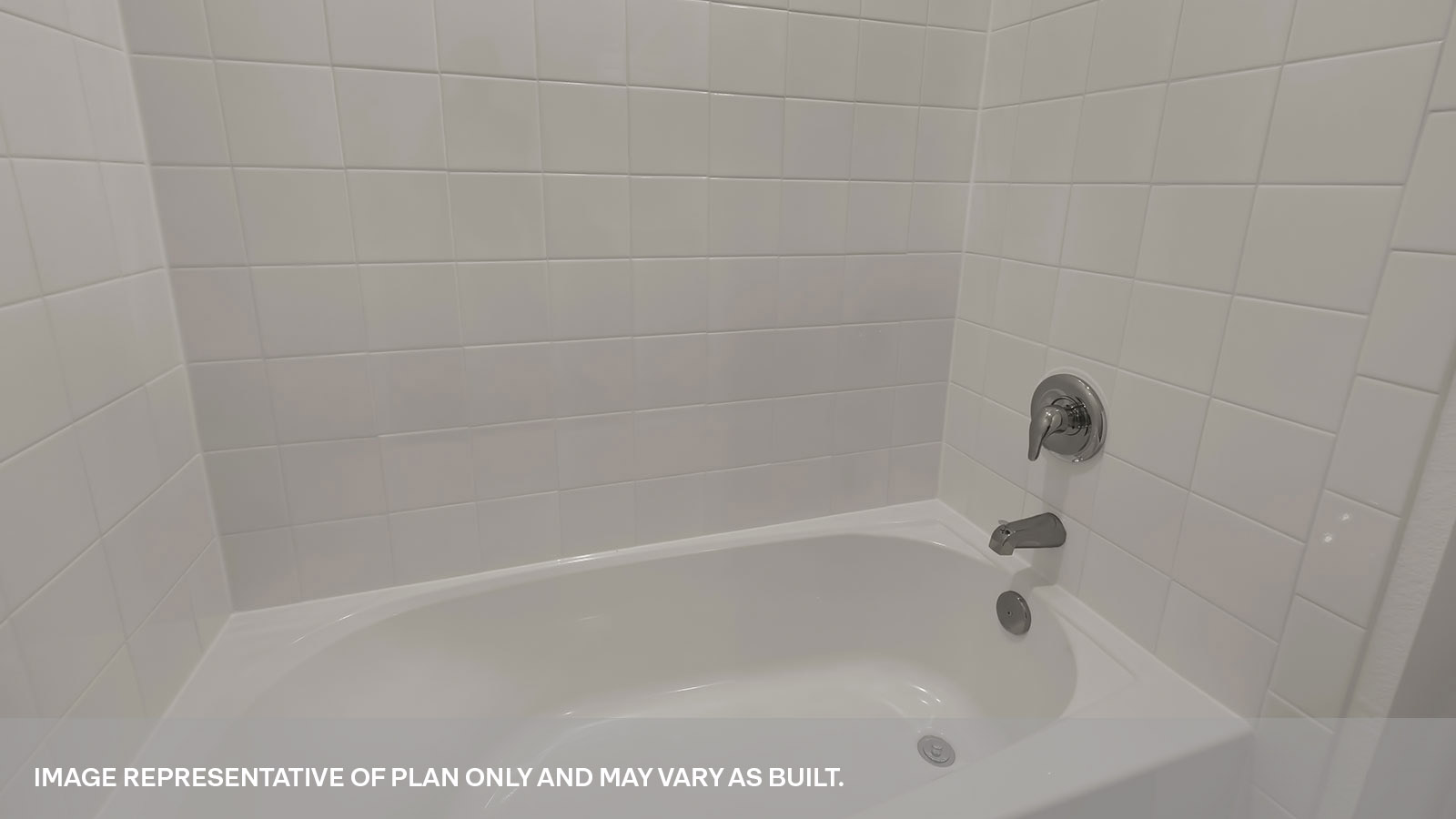 Hall bathroom with tub and tile surround.