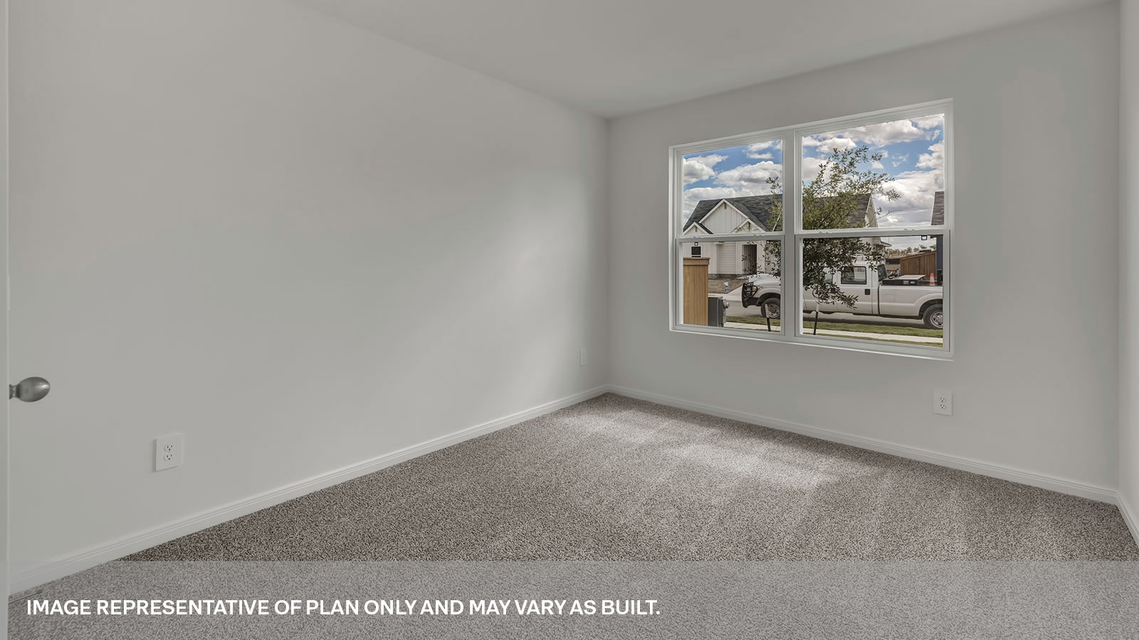 Front bedroom with carpeting and one window.