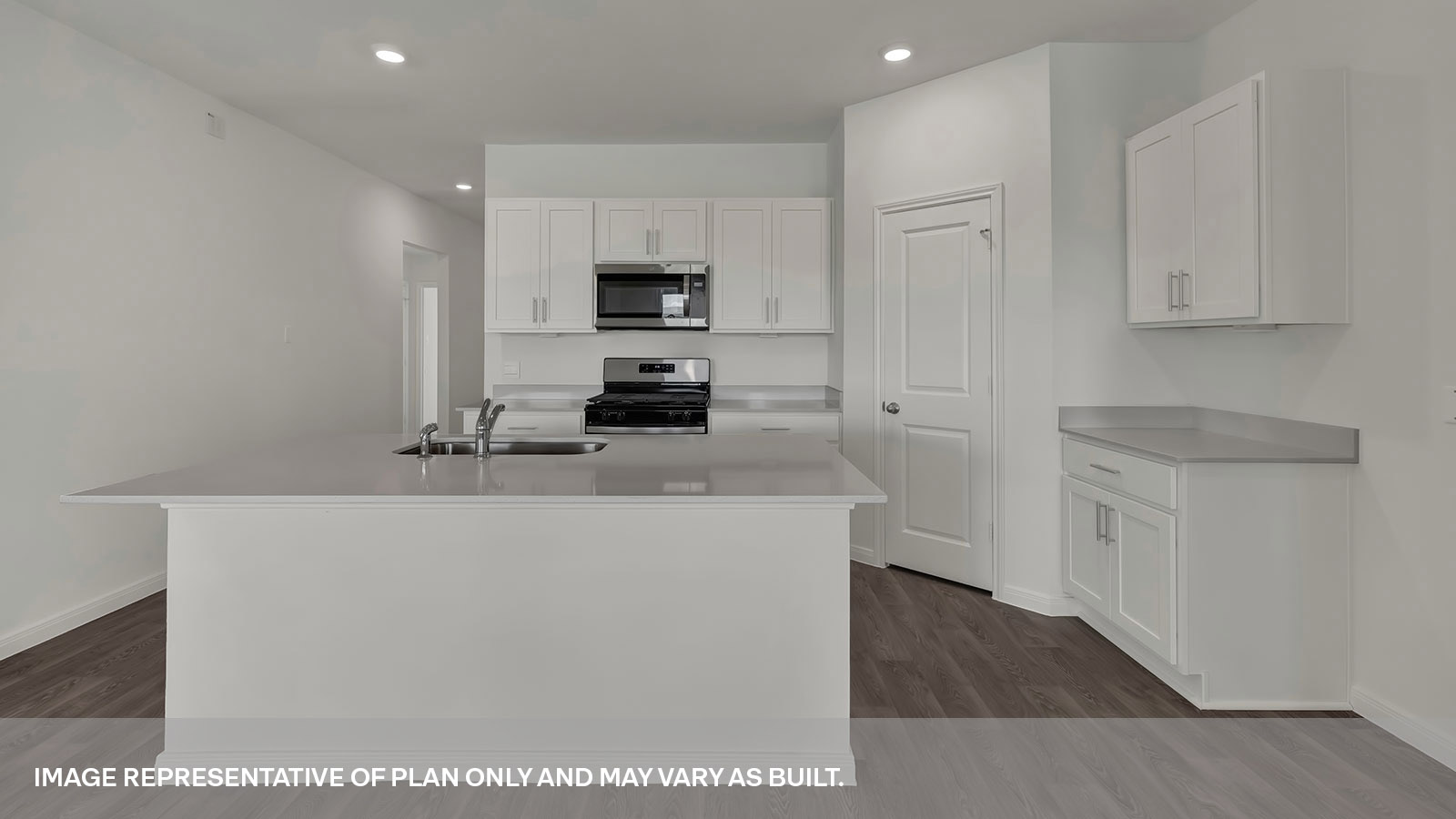Kitchen with kitchen island and white cabinets.