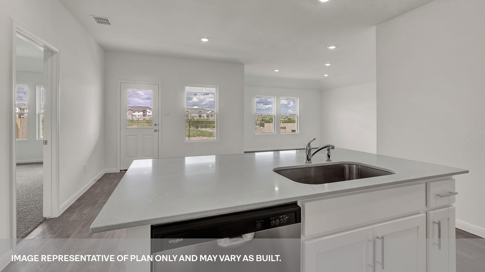 Kitchen island with large kitchen sink looking over the living room.