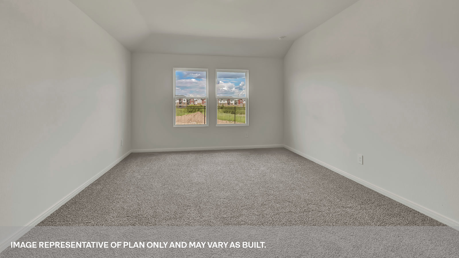 Main bedroom with carpeting and two windows.