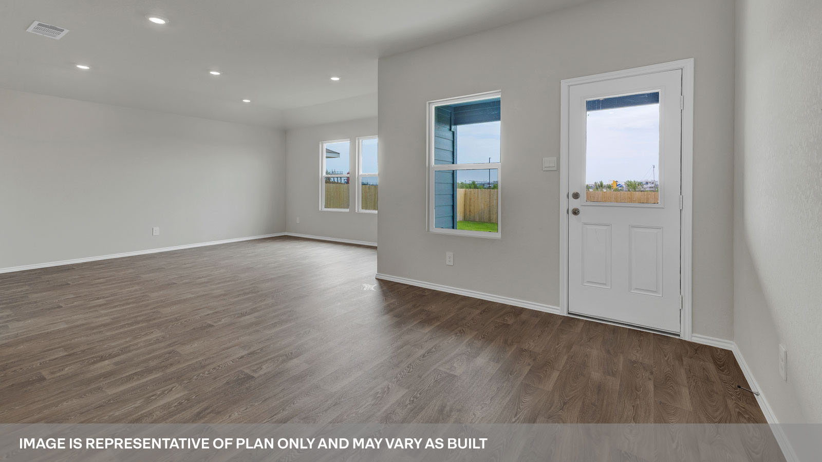 Dining room with vinyl flooring and two windows.