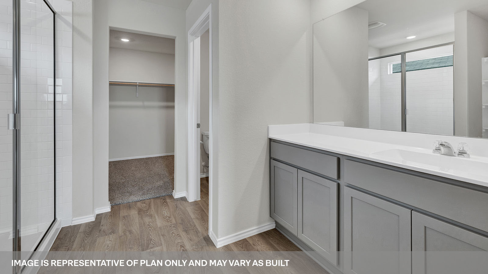 Main bathroom with double sink vanity, shower and closet.