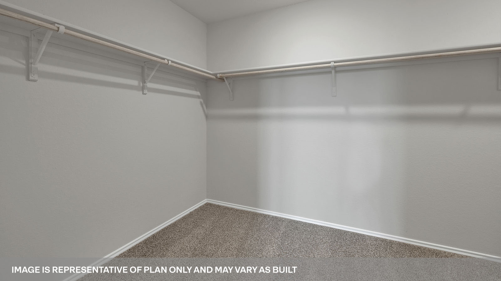 Main bedroom closet with carpeting and wooden shelving.