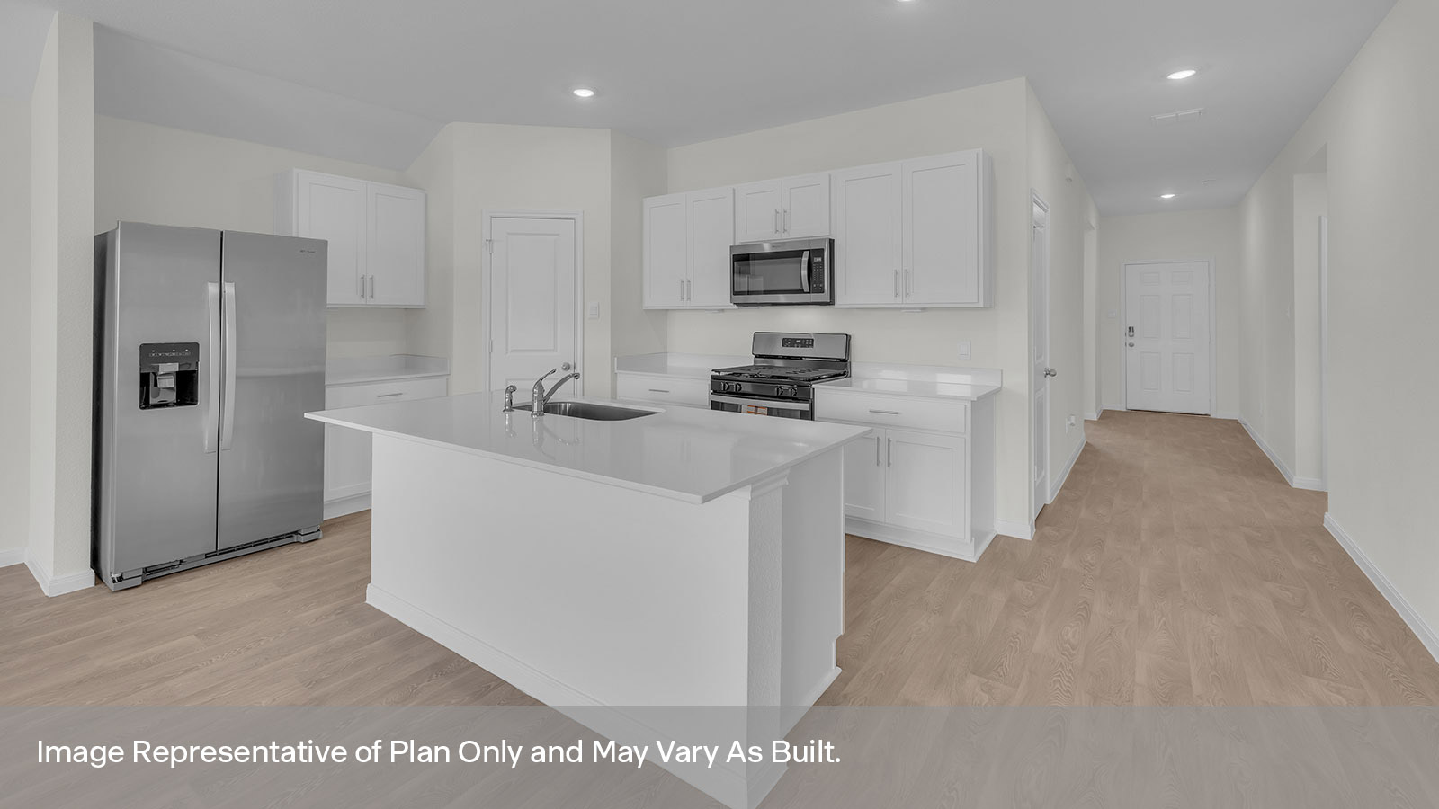 Kitchen with kitchen island and entry hallway.
