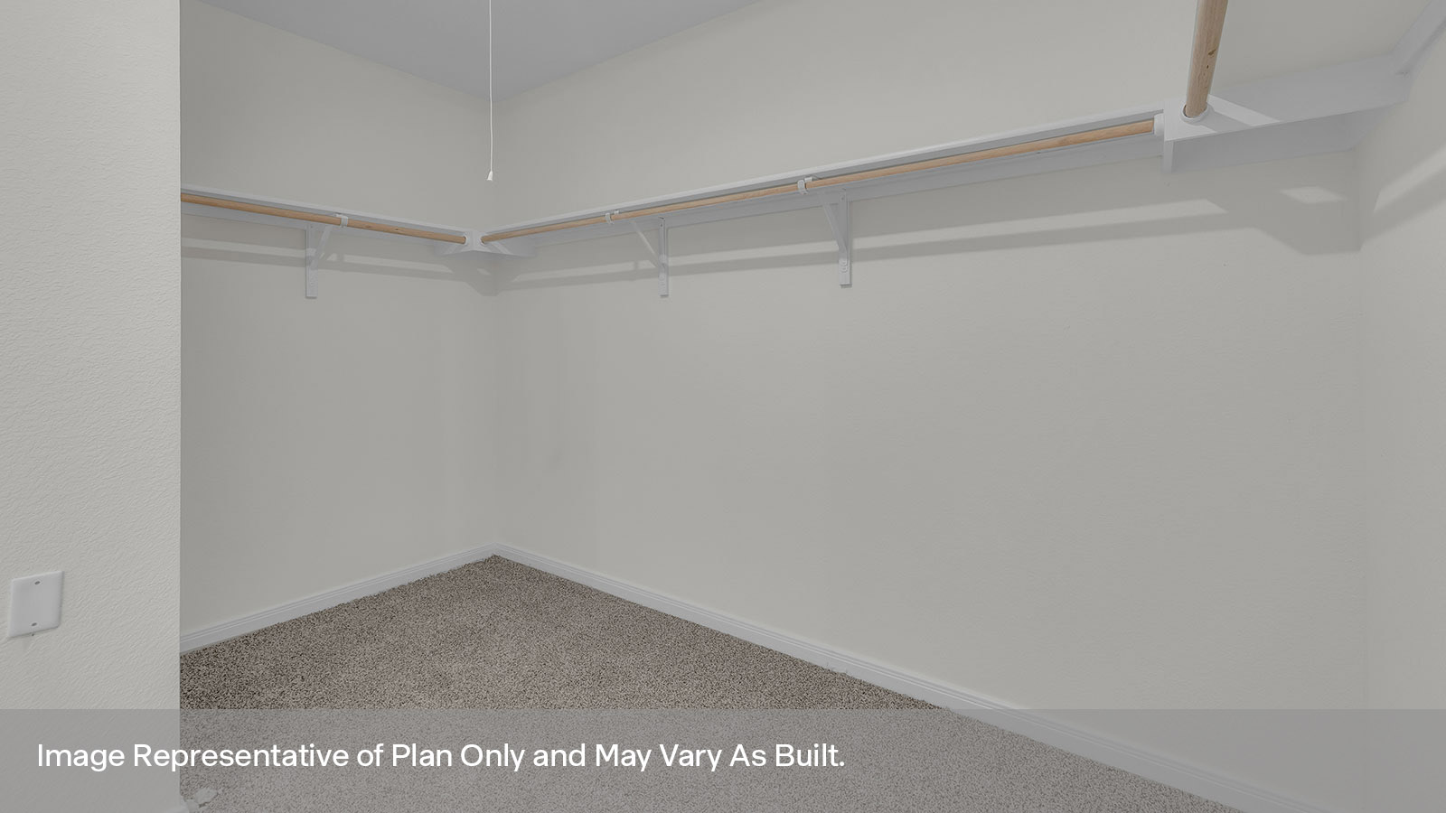 Main bedroom closet with carpeting and wooden shelving.