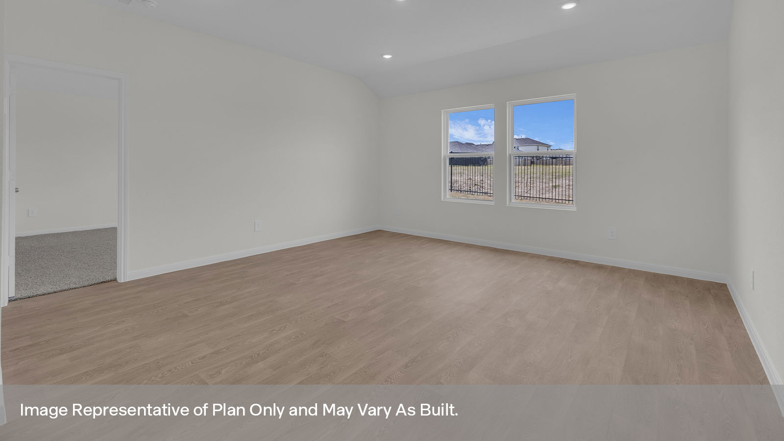 Living room with vinyl flooring, 2 windows, and a half lite exterior door.