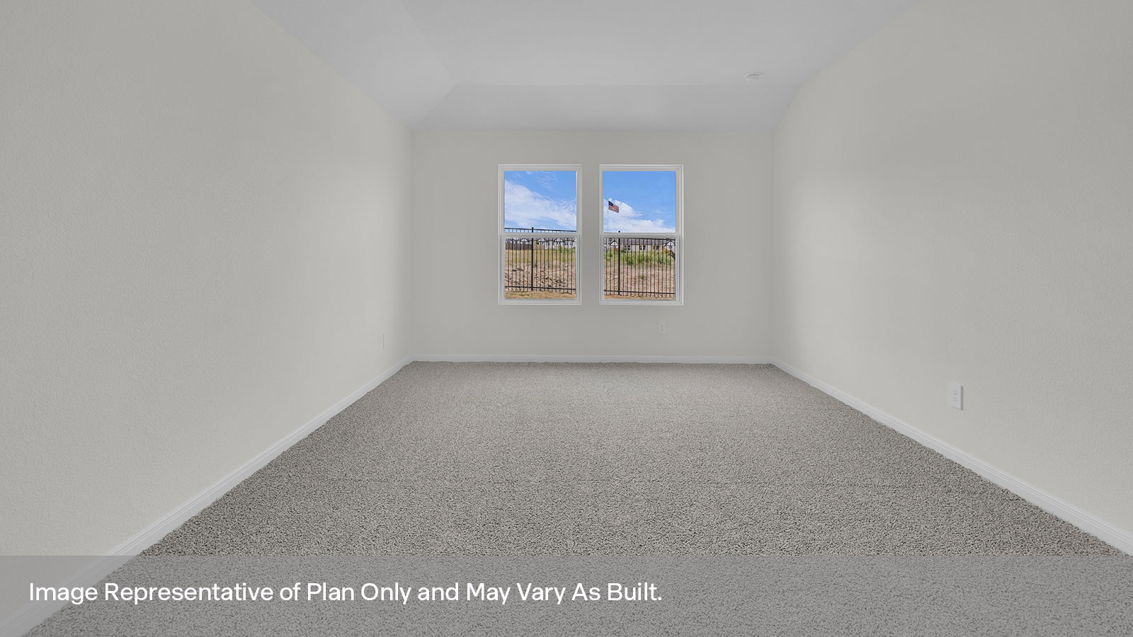 Main bedroom with carpeting and two windows.