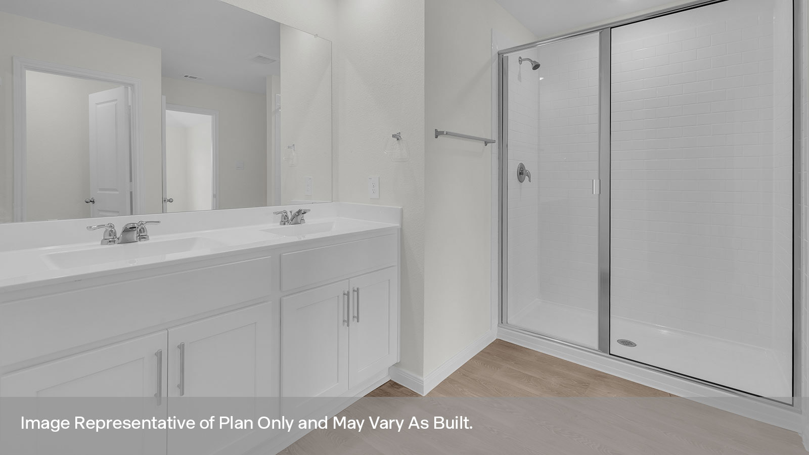 Main bathroom with double sink vanity and white cabinet, walk-in shower, and closet entry.