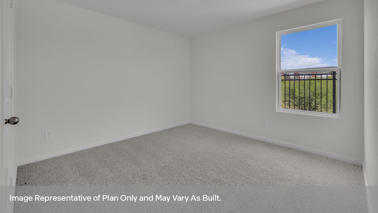 Bedroom with carpeting and one window looking into the side yard.