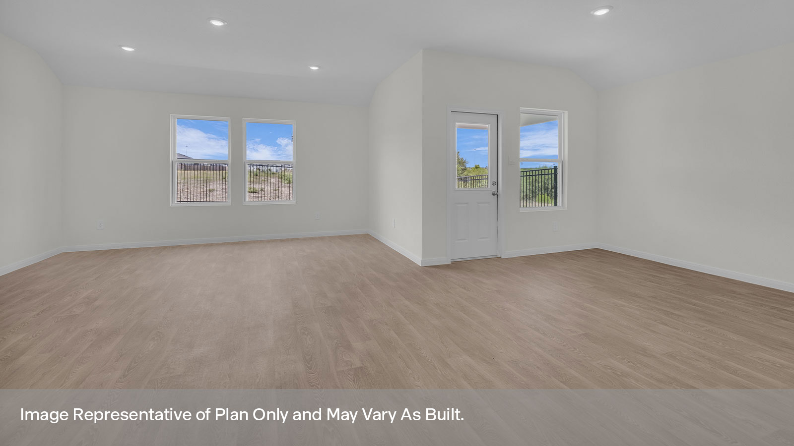 Living room opening to the dining room with 3 windows and a half lite exterior door.