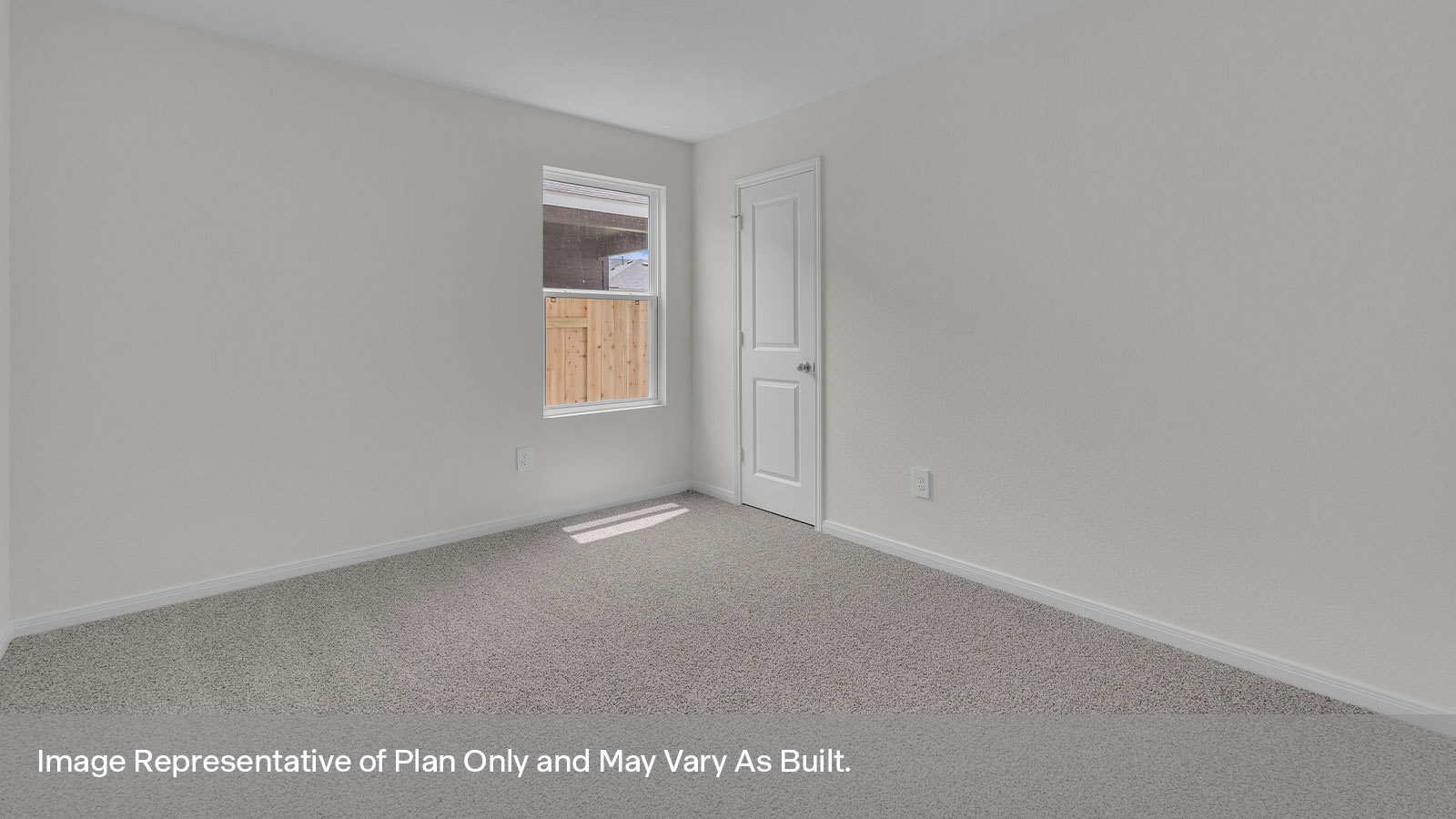 Bedroom with carpeting and one window looking into the side yard.