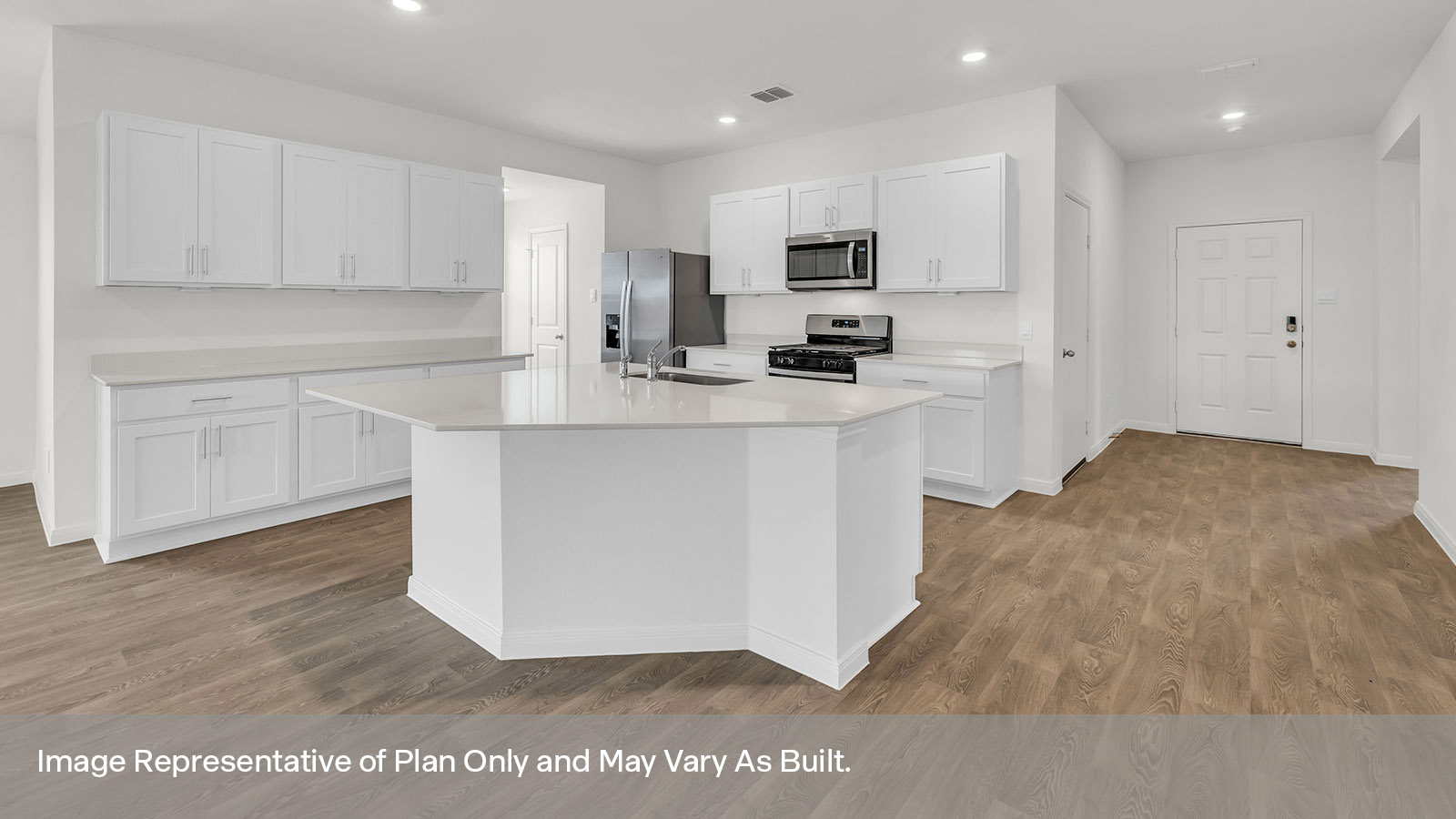 Kitchen with kitchen island and entry hallway.