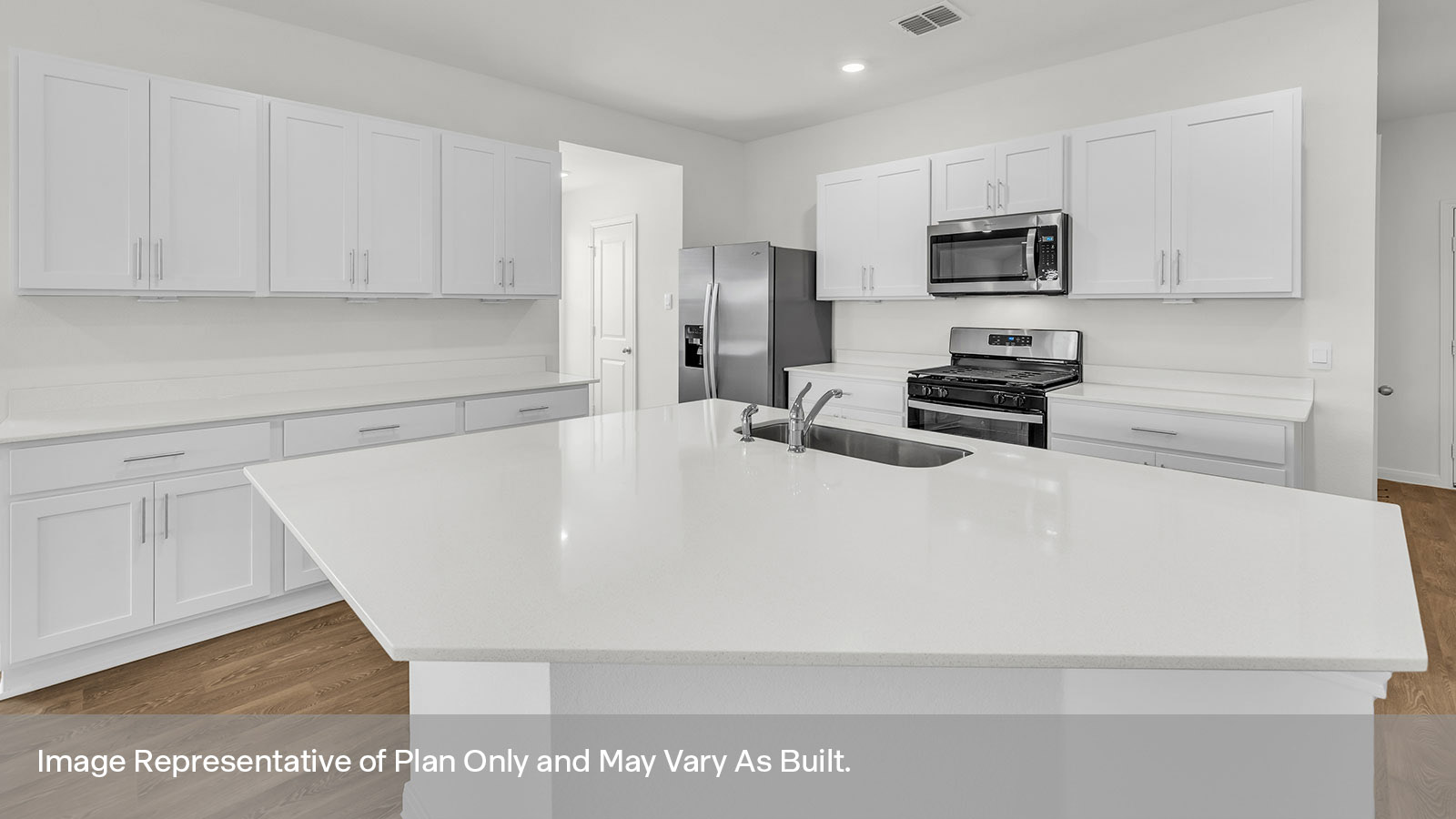Kitchen island with quartz countertop and stainless steel appliances.
