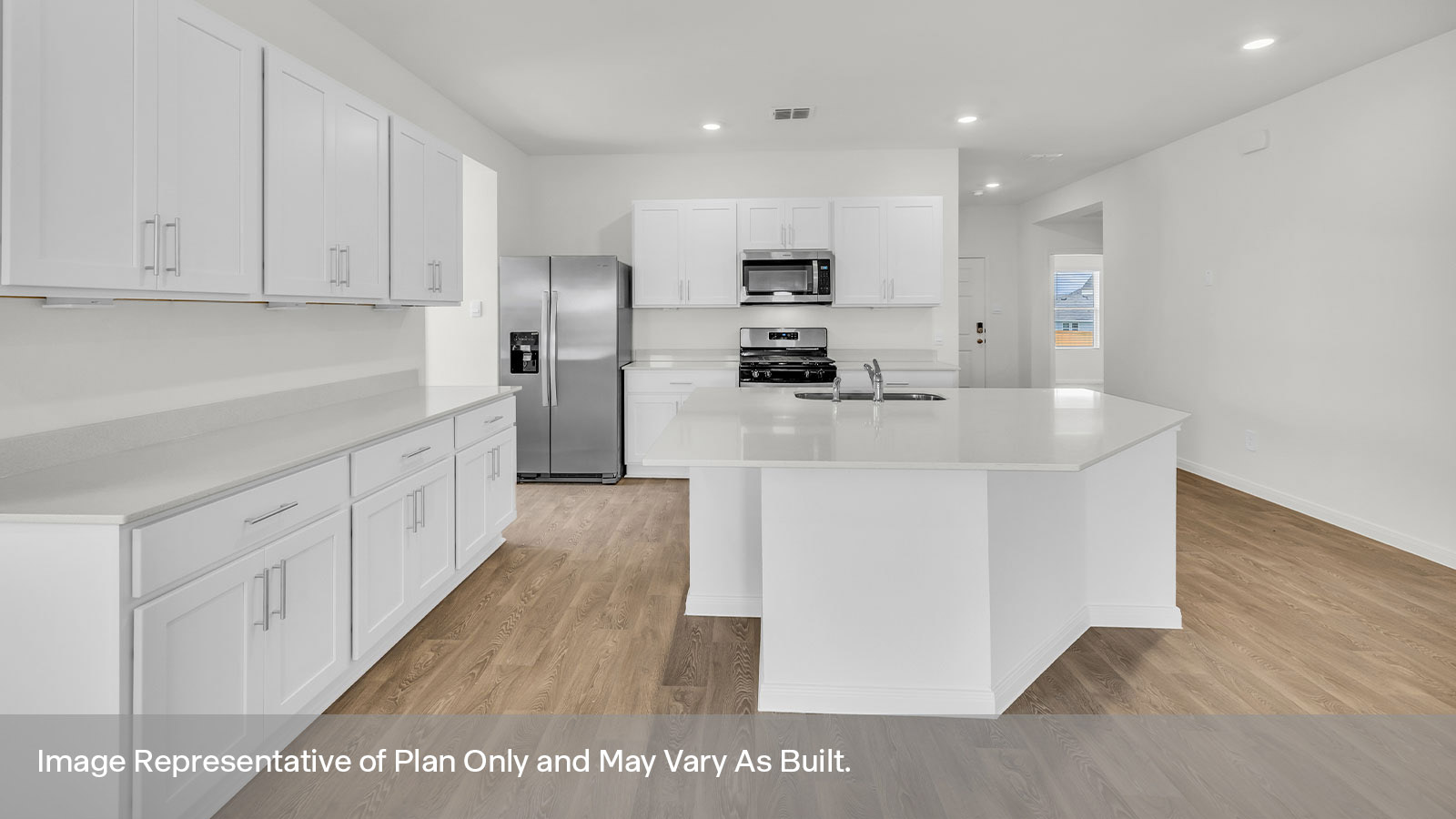 Kitchen with kitchen island and white cabinets.