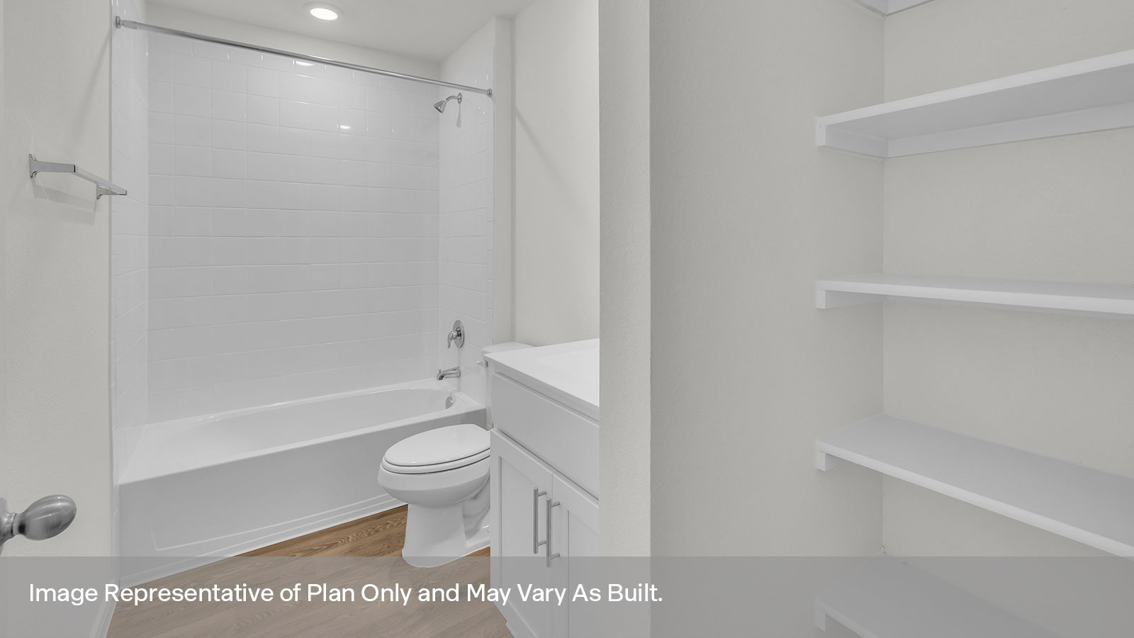 Bathroom with wooden shelving, toilet, and tile surround with tub/shower combo.