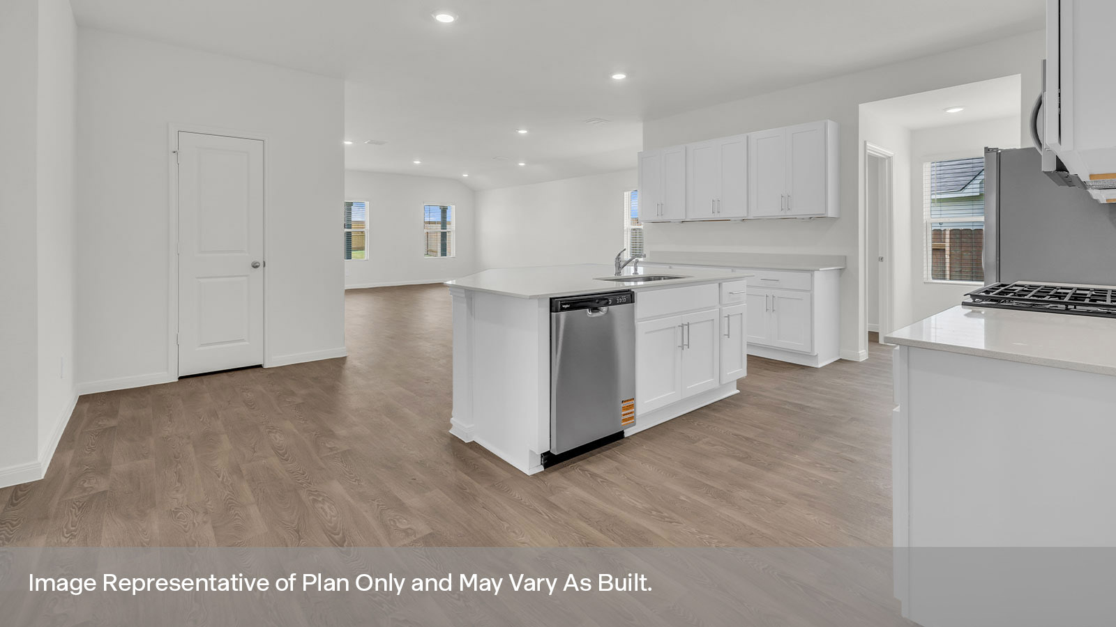 Kitchen with kitchen island with white cabinets and quartz countertops.