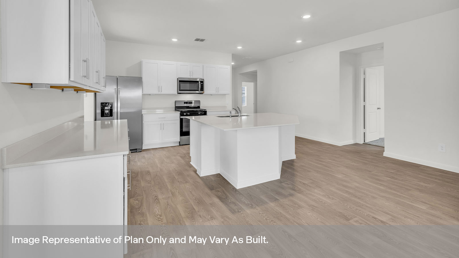 Kitchen with quartz countertops and stainless steel appliances.
